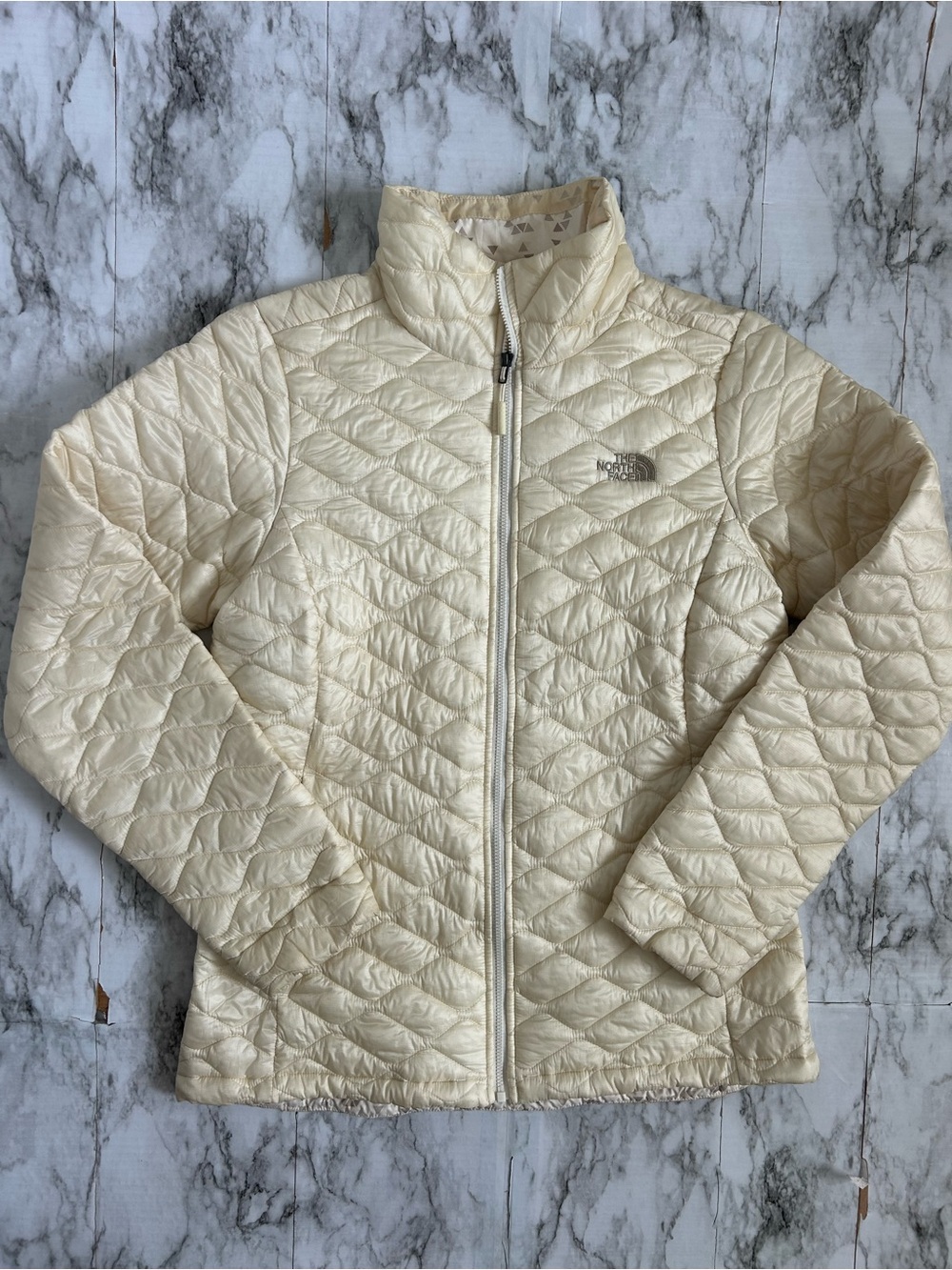 The North Face women’s size medium thermoball jacket in cream color